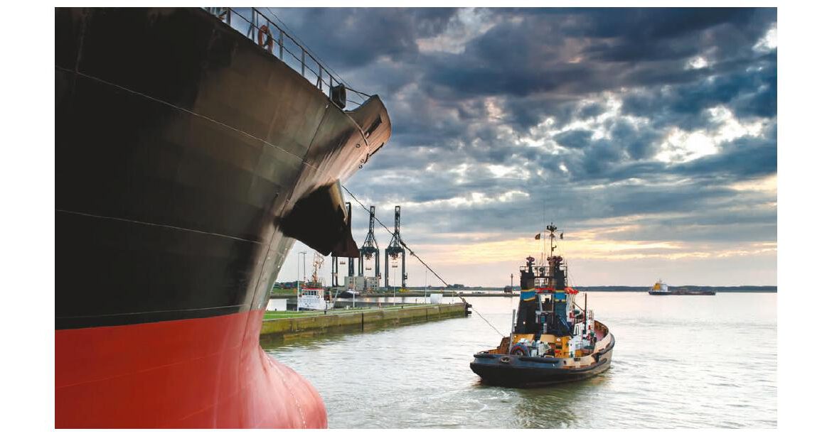 Tugboat assisting cargo ship bow docking Morocco port