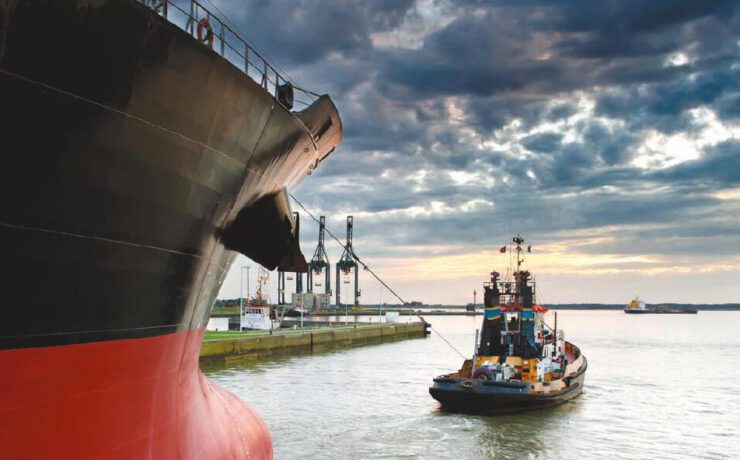 Tugboat assisting cargo ship bow docking Morocco port